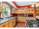 Bright kitchen features stainless steel appliances, gas stove, and red accent walls at 1687 Windy Hill Ln, Great Falls, SC 29055