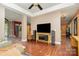 Open-concept living area with hardwood floors, a TV, and seamless flow to the kitchen at 1687 Windy Hill Ln, Great Falls, SC 29055