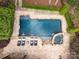Aerial view of luxurious in-ground pool, spa and patio surrounded by meticulous landscaping and lounge seating at 19614 Meta Rd, Cornelius, NC 28031