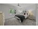 Serene bedroom features neutral tones, soft carpet, and a large window with a backyard view at 19614 Meta Rd, Cornelius, NC 28031
