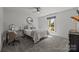 Bright bedroom with a comfortable bed, ceiling fan, desk, and ample natural light at 19614 Meta Rd, Cornelius, NC 28031