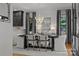 Modern dining room with a dark table, stylish chandelier, and large windows providing ample natural light at 19614 Meta Rd, Cornelius, NC 28031