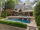 Stunning backyard with a pristine pool, waterfall features, and elegant patio perfect for outdoor entertaining at 19614 Meta Rd, Cornelius, NC 28031