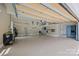 Spacious garage with overhead storage racks, ladder, cabinets, and plenty of room for multiple vehicles at 19614 Meta Rd, Cornelius, NC 28031