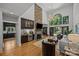 Bright living room features a stone fireplace, high ceilings, and a bar, perfect for entertaining guests at 19614 Meta Rd, Cornelius, NC 28031