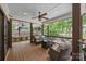 Relaxing covered porch with comfortable seating, fire pit, outdoor kitchen, and scenic backyard view at 19614 Meta Rd, Cornelius, NC 28031