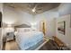 Serene bedroom features a plush bed, modern nightstands, and a stylish ceiling fan at 210 N Church St # 2613, Charlotte, NC 28202