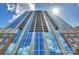 Stunning high-rise condo building with blue glass windows and private balconies under sunny skies at 210 N Church St # 2613, Charlotte, NC 28202