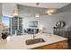 Bright living room with skyline views and kitchen with island and sink at 210 N Church St # 2613, Charlotte, NC 28202