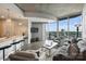 Bright living room with floor-to-ceiling windows and skyline views from the kitchen at 210 N Church St # 2613, Charlotte, NC 28202