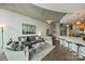 Inviting living room with gray furnishings, concrete ceiling, and an open view of the kitchen at 210 N Church St # 2613, Charlotte, NC 28202