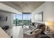 Open-concept living room with city views, sleek furniture, and unique concrete ceiling at 210 N Church St # 2613, Charlotte, NC 28202