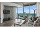 Bright living room features large windows with city views, contemporary furniture, and hardwood floors at 210 N Church St # 2613, Charlotte, NC 28202