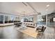 Expansive lounge with floor-to-ceiling windows, a dining table, and modern seating at 210 N Church St # 2613, Charlotte, NC 28202