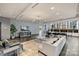Open lounge area featuring modern furniture, a TV, and dining space near windows at 210 N Church St # 2613, Charlotte, NC 28202