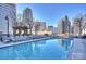 Rooftop pool with lounge chairs offers city views and a relaxing atmosphere in this condo community at 210 N Church St # 2613, Charlotte, NC 28202