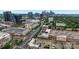 An aerial view of the city with the city skyline, retail stores and parking lots and streets busy with traffic at 2125 Southend Dr # 448, Charlotte, NC 28203
