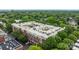 An aerial view of the complex surrounded by lush green trees with rooftop parking and architectural design at 2125 Southend Dr # 448, Charlotte, NC 28203