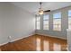 Bright bedroom with hardwood floors illuminated by natural light from three windows at 2125 Southend Dr # 448, Charlotte, NC 28203