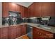 Close up of kitchen showcasing granite countertops, stainless steel appliances, and dark wood cabinetry at 2125 Southend Dr # 448, Charlotte, NC 28203