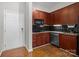 Compact kitchen featuring granite countertops, stainless steel appliances, and dark wood cabinetry at 2125 Southend Dr # 448, Charlotte, NC 28203