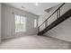 Bright living room features a staircase, a large window, and provides versatile area for a home office at 2125 Southend Dr # 448, Charlotte, NC 28203