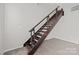 Modern staircase with metal and wood design, leading to upper level and adding architectural detail at 2125 Southend Dr # 448, Charlotte, NC 28203