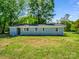 This lovely home includes a spacious backyard surrounded by mature trees and lush green grass at 2313 Eleanor Dr, Shelby, NC 28150