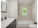 Charming bathroom with tub and shower combination, updated vanity, and natural light at 2313 Eleanor Dr, Shelby, NC 28150