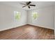 Bright bedroom features wood-look flooring, a ceiling fan, and natural light from two windows at 2313 Eleanor Dr, Shelby, NC 28150