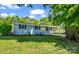 Beautiful blue home with a manicured lawn, complemented by black shutters and a bright yellow front door at 2313 Eleanor Dr, Shelby, NC 28150