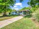 Well-maintained blue house with a covered carport, a tidy lawn, and a welcoming yellow front door at 2313 Eleanor Dr, Shelby, NC 28150