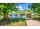 Charming blue home featuring a covered carport, freshly landscaped yard, and a sunny yellow front door at 2313 Eleanor Dr, Shelby, NC 28150