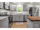 Updated kitchen with stainless appliances, light gray cabinets, butcher block island, and white subway tile backsplash at 2313 Eleanor Dr, Shelby, NC 28150