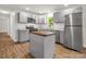 Modern kitchen featuring stainless steel appliances, gray cabinetry, new tile backsplash, and a butcher block island at 2313 Eleanor Dr, Shelby, NC 28150
