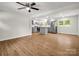 Open concept living room showcasing laminate floors, modern lighting, and a seamless flow into the kitchen area at 2313 Eleanor Dr, Shelby, NC 28150