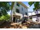 Back exterior of the house features a brick foundation, stairs, grill, and partial view of backyard at 2925 Westfield Rd, Charlotte, NC 28209