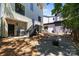 Backyard view shows a patio with a grill and steps to a gravel area with a fire pit at 2925 Westfield Rd, Charlotte, NC 28209