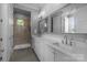 Luxurious bathroom boasts double sinks, walk-in shower with glass door, and quartz countertops at 2925 Westfield Rd, Charlotte, NC 28209