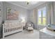 Serene Bedroom with a white crib, soft colors, and a window with decorative curtains at 2925 Westfield Rd, Charlotte, NC 28209