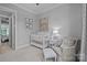 Cozy Bedroom featuring a white crib, decorative curtains, comfortable chair, and soft colors at 2925 Westfield Rd, Charlotte, NC 28209