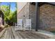 Wooden deck area with brick accents, furnished with rocking chairs, and access to the home at 2925 Westfield Rd, Charlotte, NC 28209