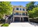 Charming two-story home featuring a brick facade, a black 2-car garage, and an inviting second-story porch at 2925 Westfield Rd, Charlotte, NC 28209