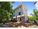 Exterior view of home reveals a backyard with a gravel area, fire pit and upper deck at 2925 Westfield Rd, Charlotte, NC 28209