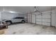 Spacious garage featuring light gray Jeep Grand Cherokee, overhead storage, and automatic doors at 2925 Westfield Rd, Charlotte, NC 28209