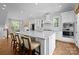 Spacious kitchen with white cabinets, marble countertops, and a large island with seating at 2925 Westfield Rd, Charlotte, NC 28209