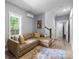 Comfortable living room with a large window, hardwood flooring, and stylish rug at 2925 Westfield Rd, Charlotte, NC 28209