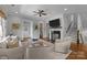 Open living room with a fireplace, hardwood floors, neutral paint, and a ceiling fan at 2925 Westfield Rd, Charlotte, NC 28209