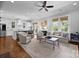 Open-concept living room with a kitchen view, comfortable seating, and natural light at 2925 Westfield Rd, Charlotte, NC 28209