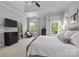 Spacious main bedroom with neutral carpet, ceiling fan, and large windows at 2925 Westfield Rd, Charlotte, NC 28209